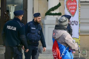 policjanci przed sztabem WOŚP w Opolu